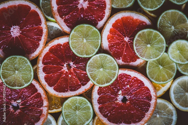 Fototapeta Slices of pink Star Ruby grapefruit and green lime