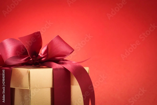 Fototapeta Valentine festival , New year Gold gift box with red ribbon. Red background for create idea copy space.