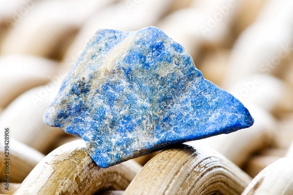 Fototapeta Macro photography of a lapis lazuli stone on a wicker background