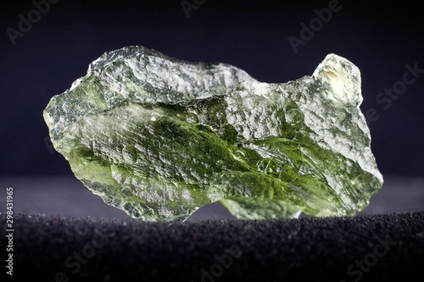 Fototapeta Macro photography of a moldavite stone on a black background