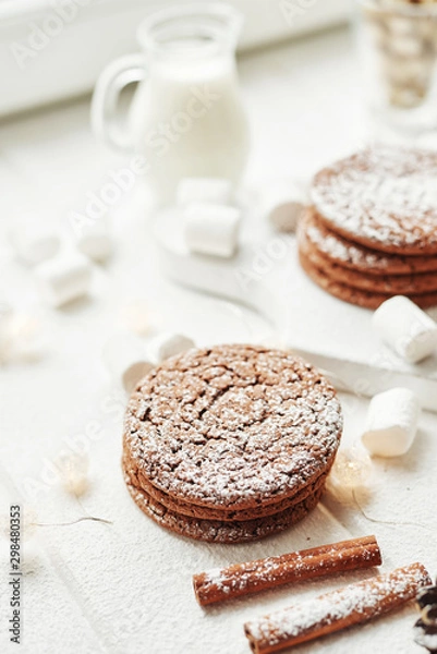 Fototapeta Christmas cookies and marshmallows on a white background by the window