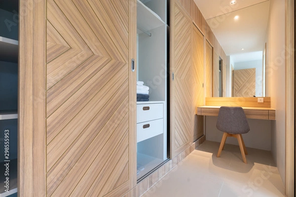 Fototapeta built in wooden wardrobe with working table and chair in bedroom