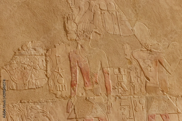 Fototapeta Ancient egyptian paintings and hieroglyphs on a wall in Mortuary temple of Hatshepsut in Luxor, Egypt