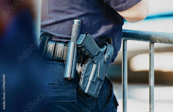 Fototapeta Manhattan 2019. Behind the police with gun belt