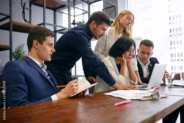 Fototapeta young office workers having some problems, trying to overcome them, solve them, difficulties in business, failure