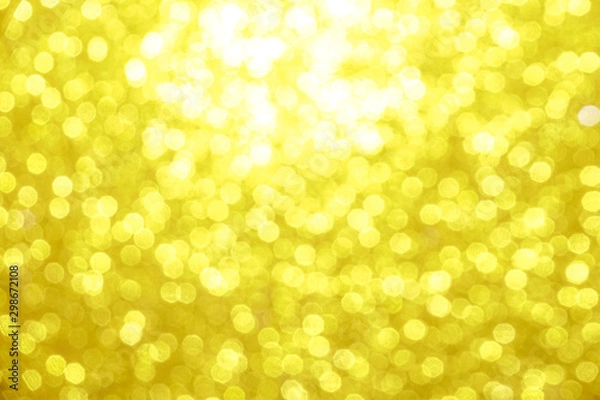 Fototapeta gold Sparkling Lights Festive background with texture. Abstract Christmas twinkled bright bokeh defocused and Falling stars. Winter Card or invitation	