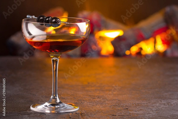 Obraz Manhattan cocktail on fireplace background
