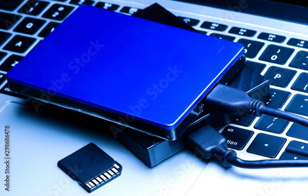 Fototapeta External disk hard drive connected to notebook