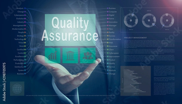 Obraz Businessman outreached hand holding a Quality Assurance business concept on a computerised screen display.