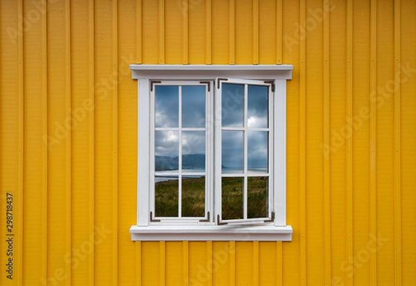 Obraz Typical icelandic yellow house with white frame and landscape reflection