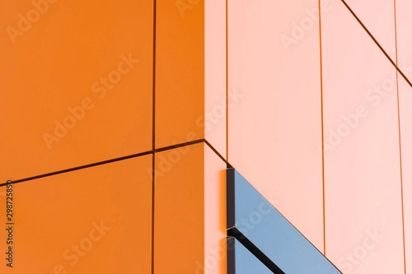 Obraz Geometric color elements of the building facade with planes, lines, corners with highlights and reflections for an abstract background and texture of gray, orange, blue colors. Place for text