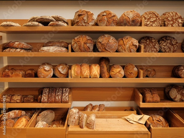 Fototapeta Modern bakery with different kinds of bread, cakes and buns