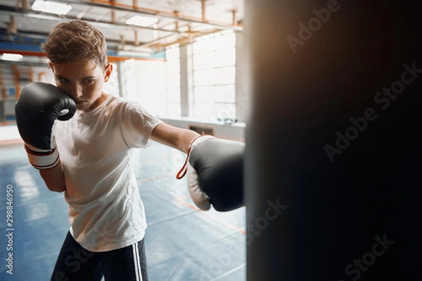 Fototapeta agressive angry boy is good at kickboxing, close up photo. motivation concept