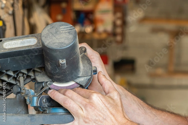 Obraz man hands Cutting his fingers with industrial machinery with workshop in the background
