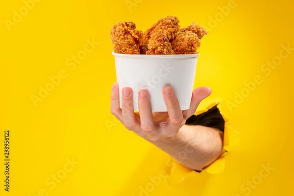 Obraz Hand giving chicken nuggets