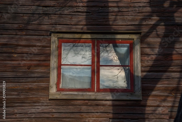 Fototapeta Winow in a logg house wall from 1800s