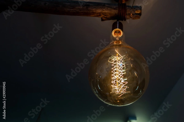 Obraz Ampoule ronde à filaments au style industriel	