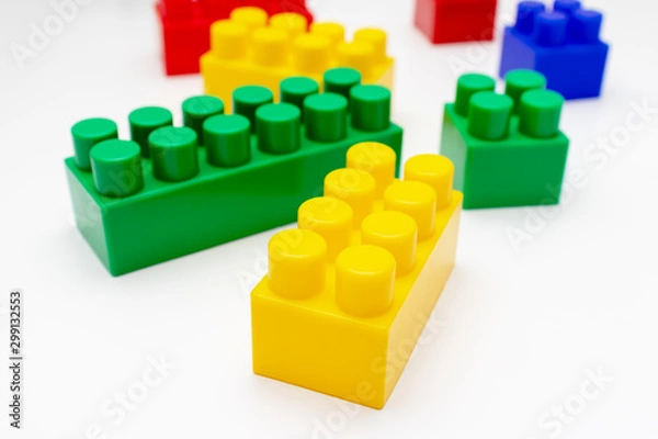 Fototapeta Many colorful toy plastic bricks, kit of blocks for building and constructing on white background, Children's game and playing concept
