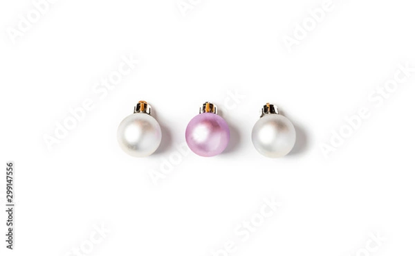 Fototapeta White and pink Christmas decorations lie in a row on a white background, minimal style, flat lay.