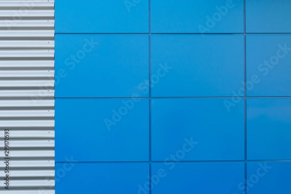 Fototapeta Geometric colored building facade elements with planes, lines and corners with light flare and reflections for an abstract background and texture of white, blue, gray colors. Place for text