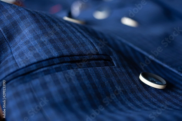 Fototapeta The blue suit cloth was laid on the floor and there was space for adding text. Blue fabric with buttons and pockets for tailoring.