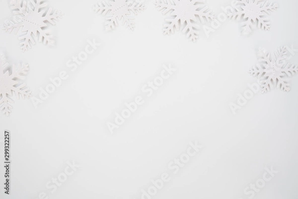 Obraz Christmas composition. Christmas frame made of snowflakes on white background. Winter concept. Flat lay, top view, copy space .