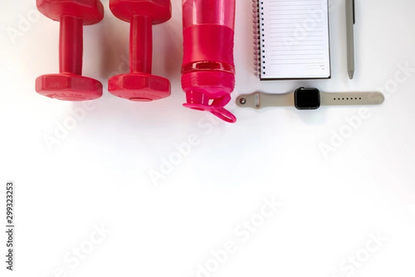 Fototapeta Do fintess in gym. Dumbbells, smart watch, bottle of water, blank notebook on white background top view space for text pattern.