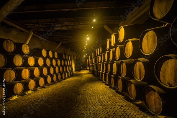 Fototapeta Barrels of wine in the wine cellar one of the famous wineries in Porto in Portugal  which is making an amazing wine and port wine.