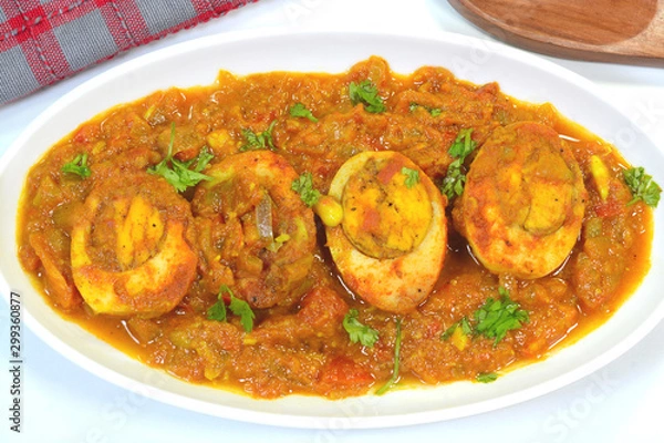 Fototapeta Spicy egg curry dish garnished with coriander leaves