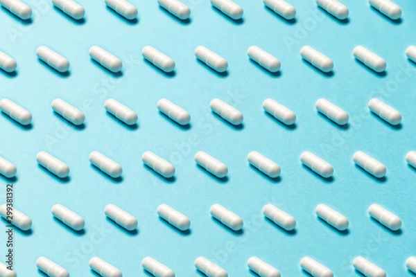 Obraz Trendy pattern made with Pharmaceutical medicine pills, tablets and capsules on bright light blue background. Medicine creative concepts. Minimal style with colorful paper backdrop. Trendy colors