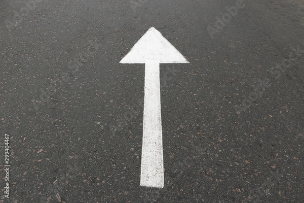 Fototapeta Road marking on asphalt with direction of movement