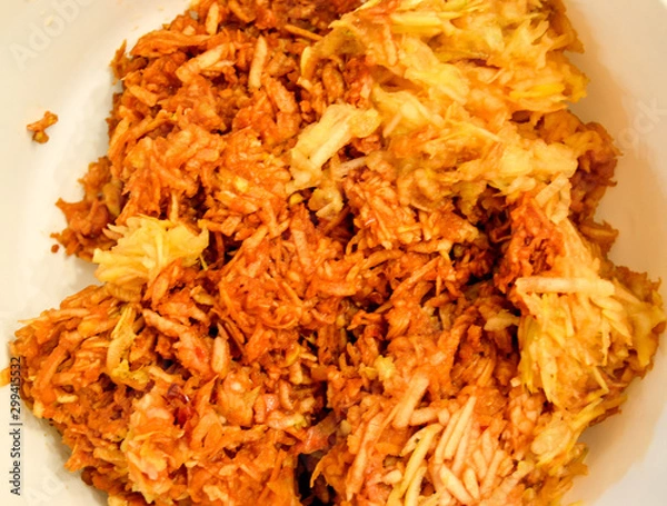 Fototapeta Apples grated on a grater appetizing looking brown juicy apples. Natural homemade pie