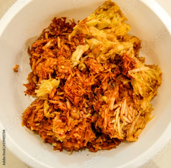 Obraz Apples grated on a grater appetizing looking brown juicy apples. Natural homemade food