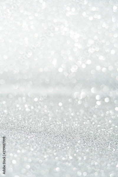 Fototapeta Silver Sparkling Lights Festive background with texture. Abstract Christmas twinkled bright bokeh defocused and Falling stars. Winter Card or invitation	