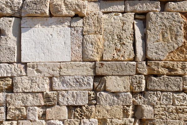 Fototapeta Texture of a antique stone wall. Old castle stone wall texture background. Stone wall as a background or texture.