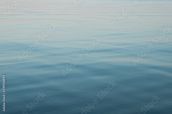 Fototapeta Abstract background of blue water, sea. Blurred background. Rippled water texture. Abstract background of the sea surface.