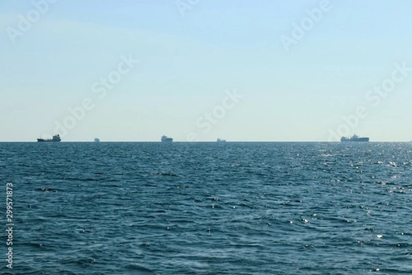 Fototapeta seascape in the open sea with a view of the ships