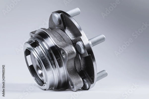 Obraz New Wheel hub assembly with bearing. This is part of the car suspension on a gray background with a gradient. The concept of new car parts
