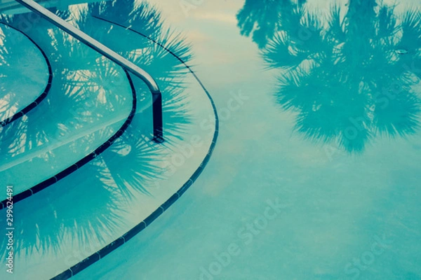 Fototapeta Abstract teal background with palm trees reflected into a Hollywood glamour style swimming pool.