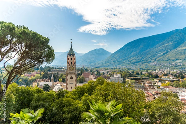 Fototapeta Ansicht alte Stadt Meran in Südtirol mit Bergen, blauem Himmel und Pfarrkirche St. Nikolaus	