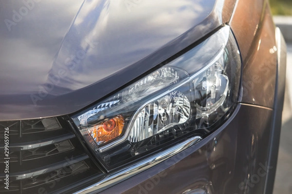 Obraz headlight of  modern car closeup