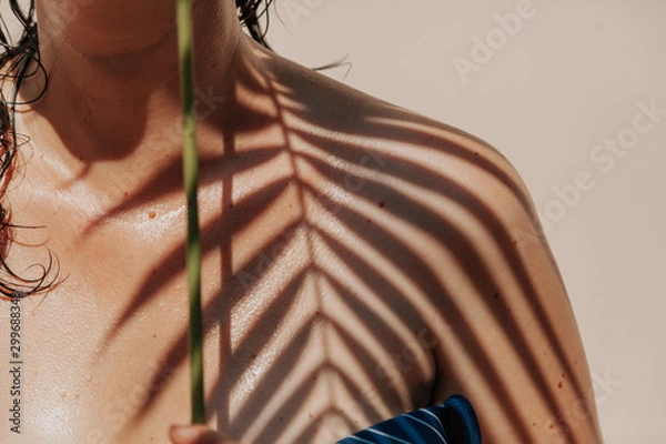 Obraz Shadow of palm tree on girl bare shoulder