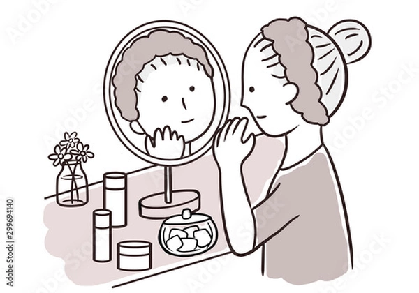 Obraz 鏡を見てスキンケアをする女性