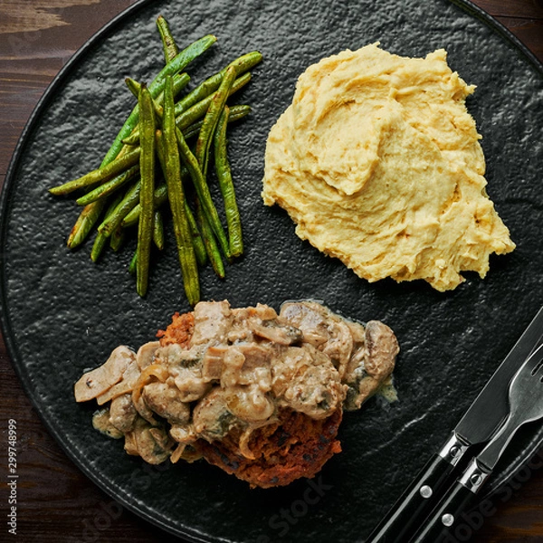 Obraz Meat Burger with Mushroom Gravy, Smashed Potatoes and Green Beans on Wooden table. Top view, directly above.