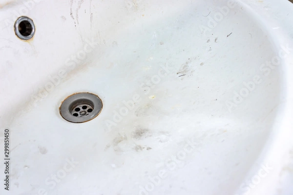 Fototapeta Old dirty washbasin with rust stains, limescale and soap stains in the bathroom