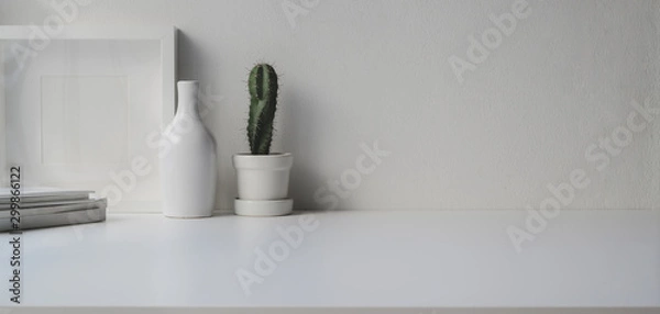 Fototapeta Minimal office room with copy space and decorations on white wooden table