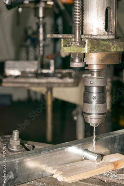 Fototapeta drill bit drills a hole in the metal part