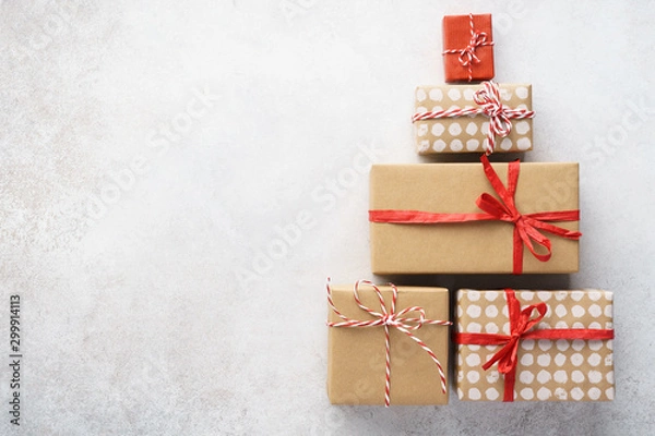 Fototapeta Christmas tree shape made of gift boxes on light gray background