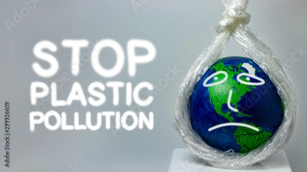 Fototapeta Stop plastic pollution. A plastic stretch film kills the planet earth.