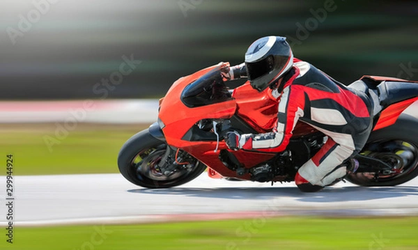 Fototapeta Motocykl wjeżdżający w szybki zakręt na torze wyścigowym